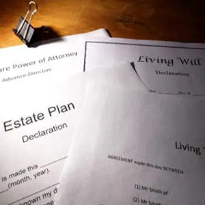 A stack of estate planning documents on a wooden desk - The Greene Law Firm