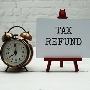 Alarm clock and tax refund sign, highlighting IRS tax refund myths