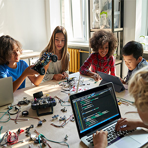 Diverse students working on a STEM project with a laptop and electronics, classroom expenses and South Carolina teachers. 