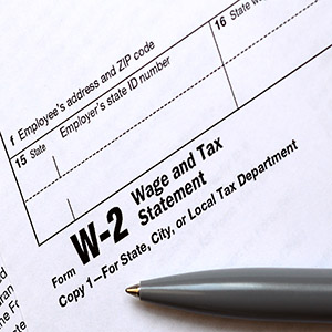 W-2 Wage and Tax Statement form with a pen; text: What Happens If Your Employer Files Incorrectly?
